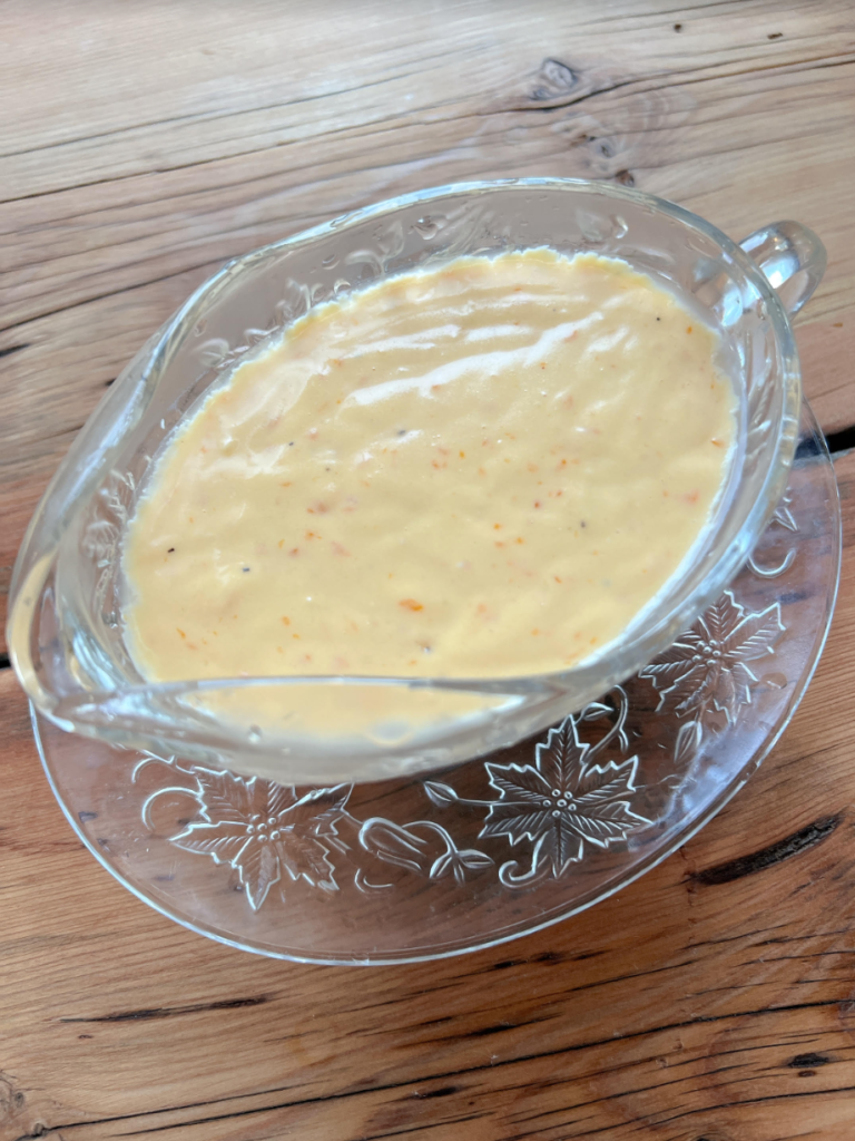 A glass bowl full of Grandma's Tweedy's White Sauce.