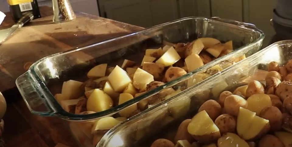 A casserole dish with potatoes that are diced in the bottom.