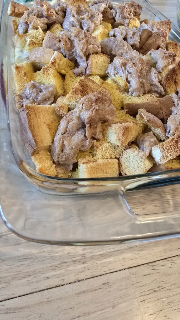 A glass casserole dish with pumpkin spice baked french toast casserole.