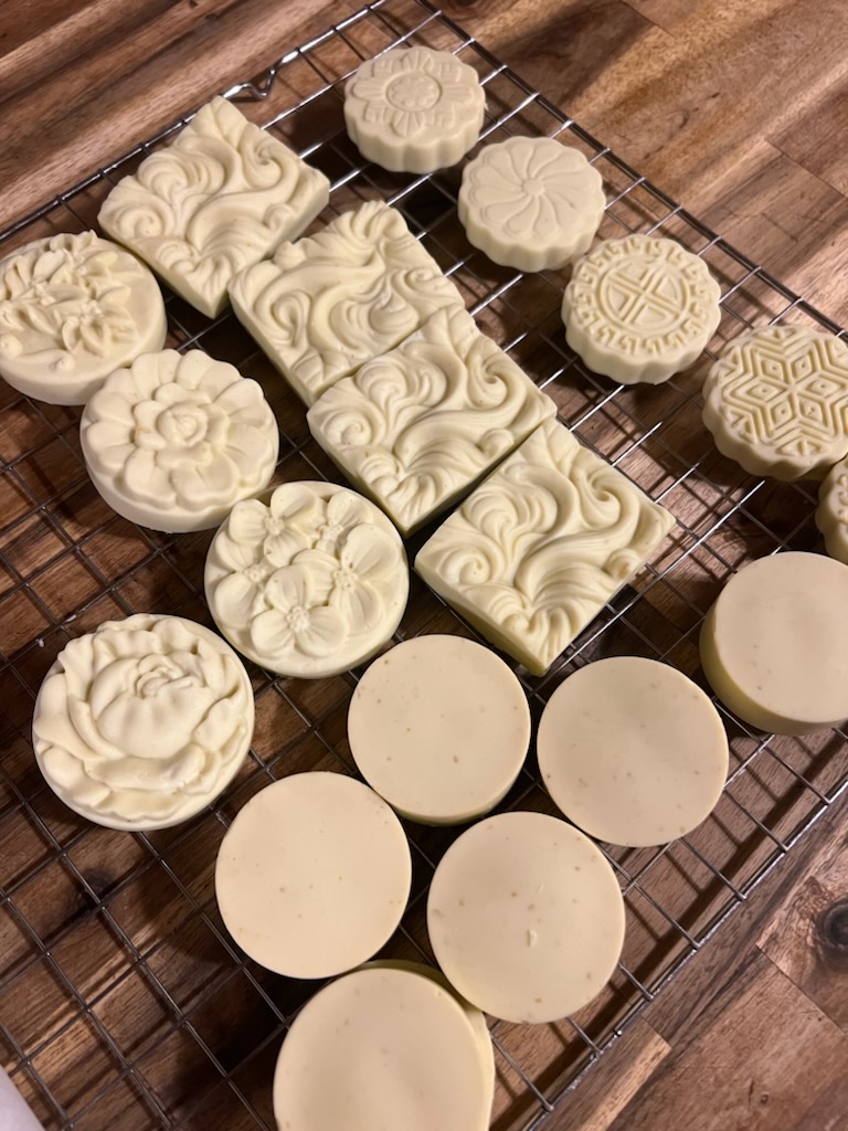 Circular and Square bars of cream colored homemade soap.