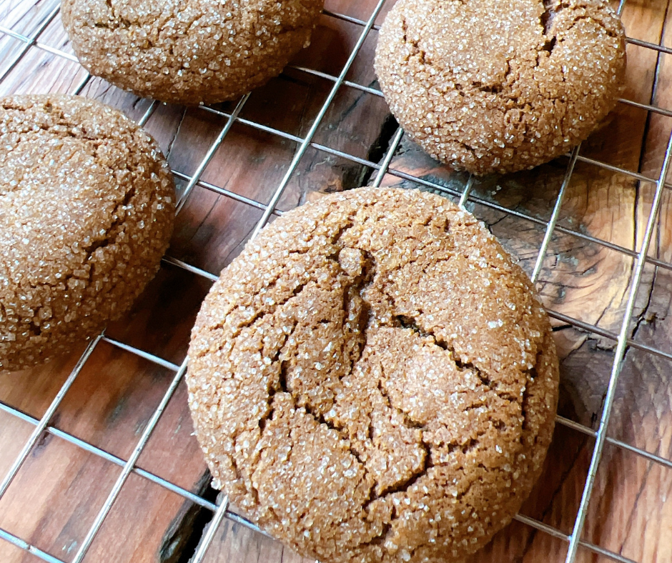 Chewy ginger snap cookies on a cooling rack.