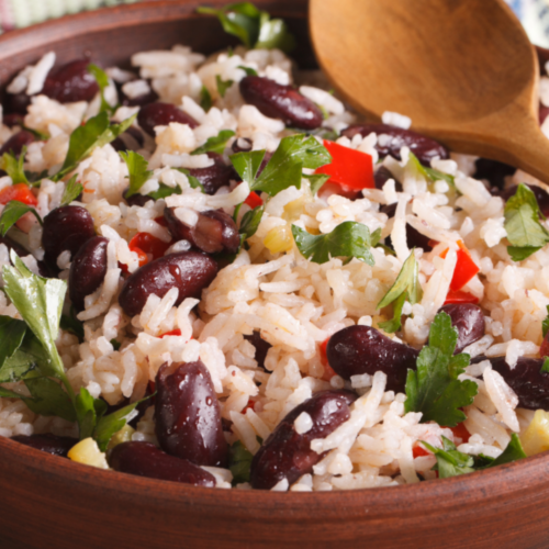 Brown bowl with beans, rice and vegetables.