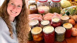 Chelsea in front of some groceries from her pantry on a table.