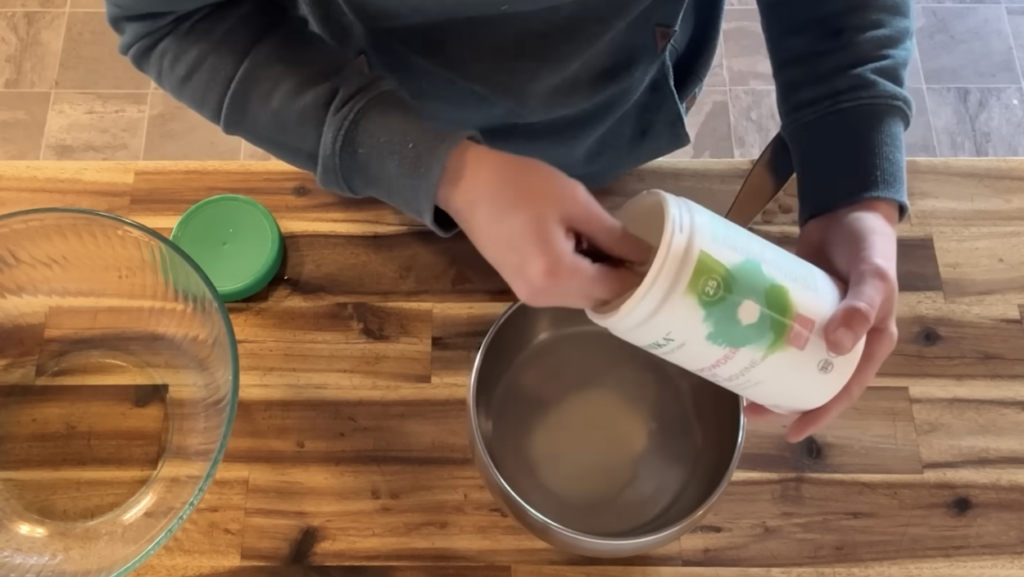 Pouring bovine gelatin into a pot to make some homemade jello.
