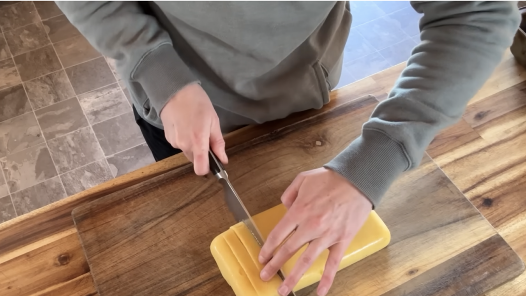 Cutting up set cornmeal mash into sticks.