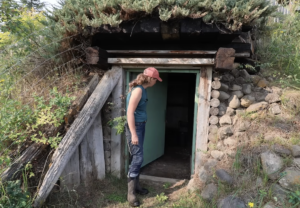 Chelsea opening the door to her root cellar.